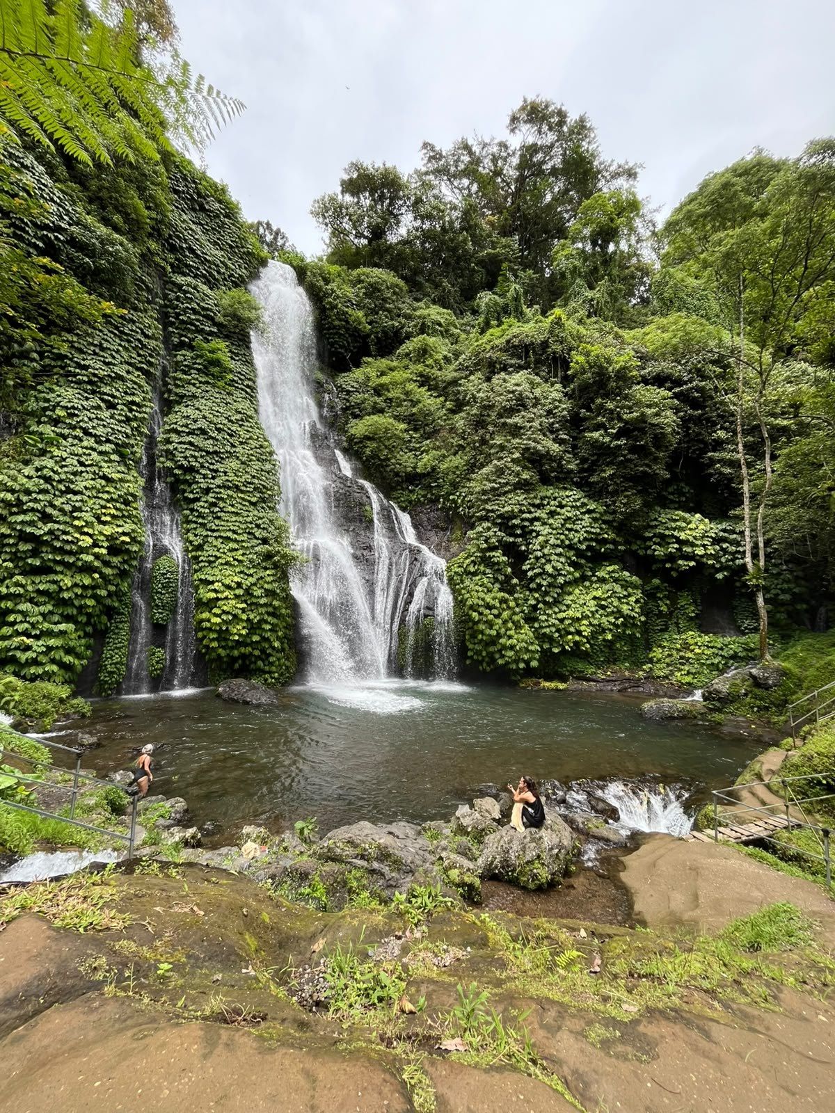 Waterfall and pool at the end of a forest path near Munduk